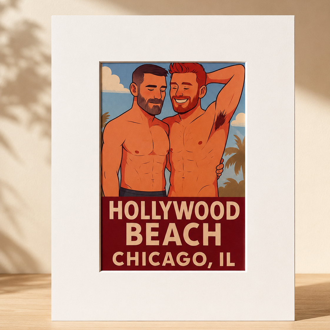A matted art print featuring a retro-style illustration of two shirtless men standing on a beach with palm trees, and bold text reading 'HOLLYWOOD BEACH CHICAGO, IL' at the bottom. The print is displayed upright on a wooden surface against a warm beige wall with soft shadow overlays.